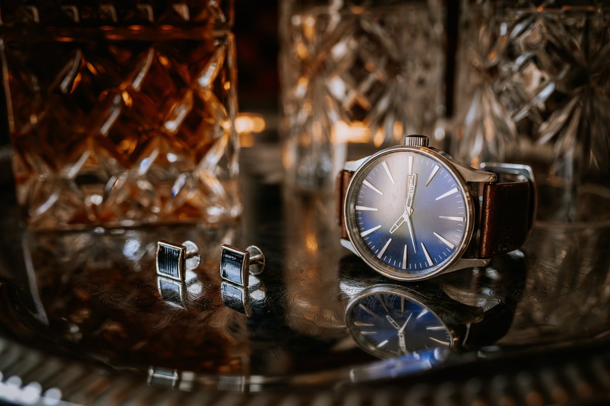 Elegant wristwatch and cufflinks on silver tray