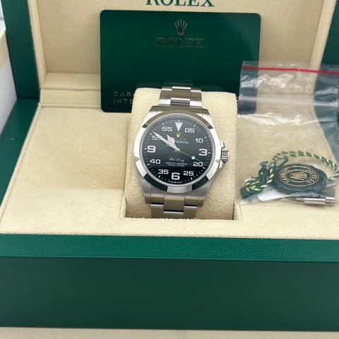New Rolex watch with stainless steel bracelet and black dial in presentation box