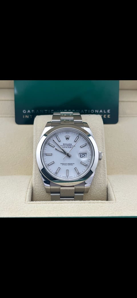 Rolex Datejust stainless steel watch with white dial displayed in presentation box with teal card